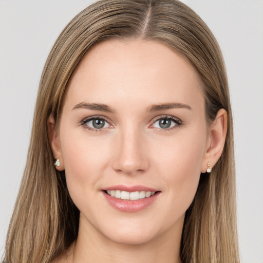 Joyful white young-adult female with long  brown hair and grey eyes