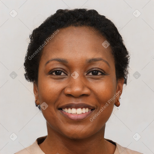 Joyful black young-adult female with short  brown hair and brown eyes