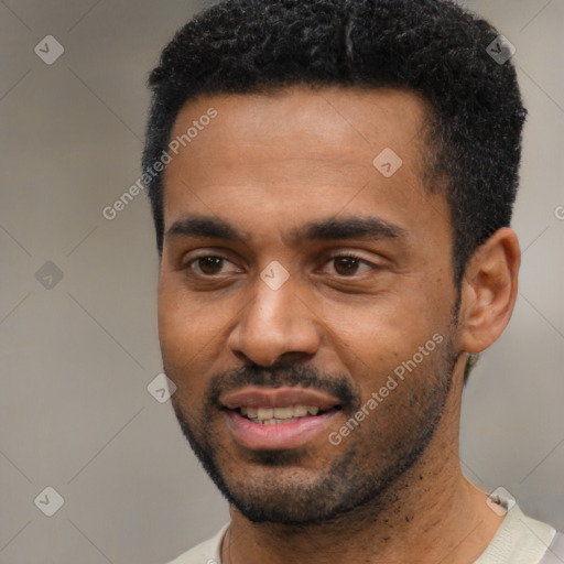 Joyful black young-adult male with short  black hair and brown eyes