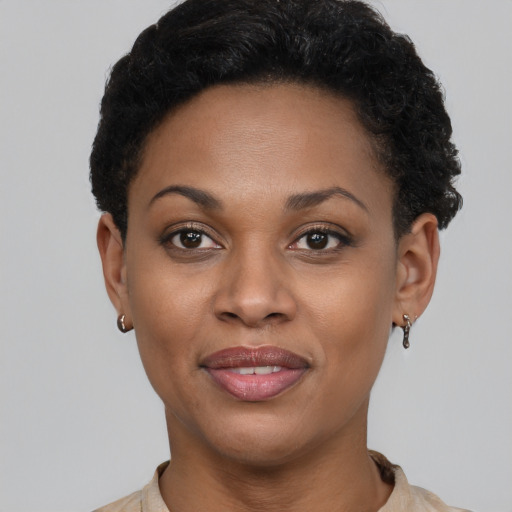 Joyful black young-adult female with short  brown hair and brown eyes