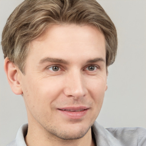 Joyful white adult male with short  brown hair and brown eyes