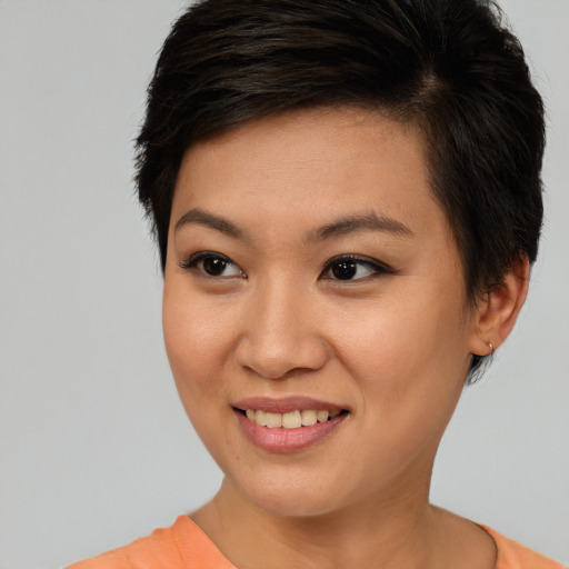 Joyful asian young-adult female with short  brown hair and brown eyes
