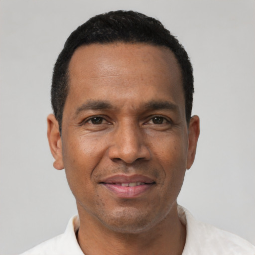 Joyful latino adult male with short  black hair and brown eyes