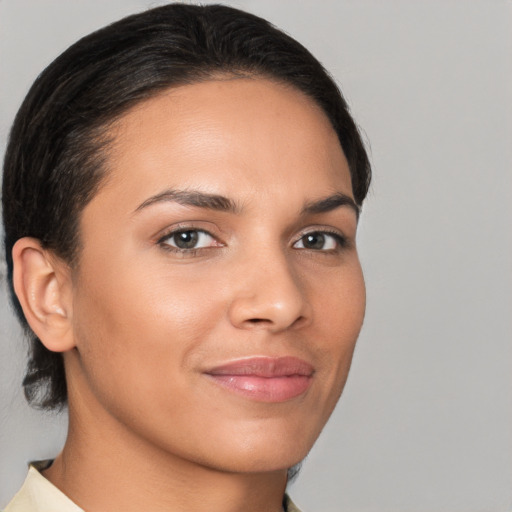 Joyful latino young-adult female with short  brown hair and brown eyes