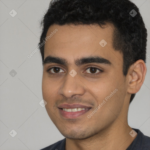 Joyful white young-adult male with short  black hair and brown eyes