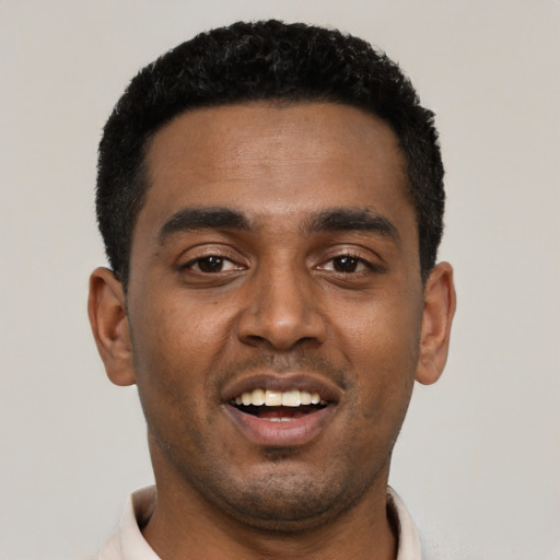 Joyful black young-adult male with short  black hair and brown eyes