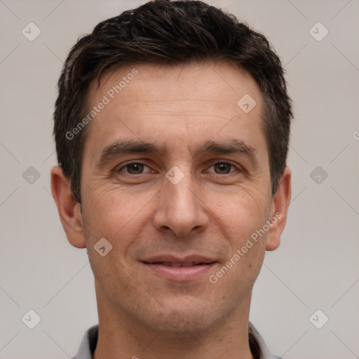 Joyful white adult male with short  brown hair and brown eyes