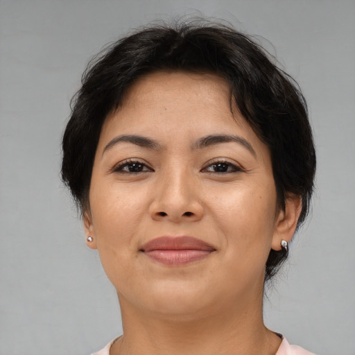 Joyful asian adult female with medium  brown hair and brown eyes
