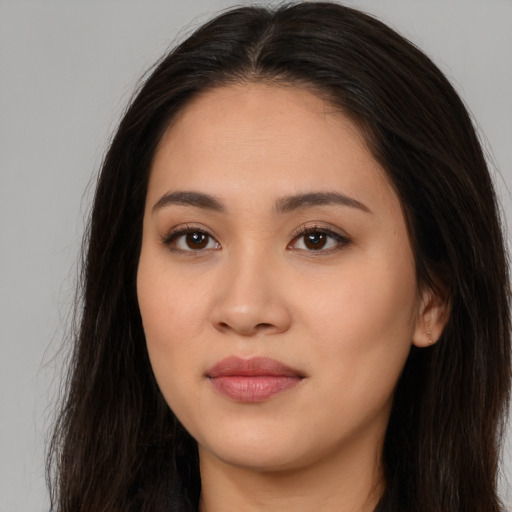 Joyful white young-adult female with long  brown hair and brown eyes