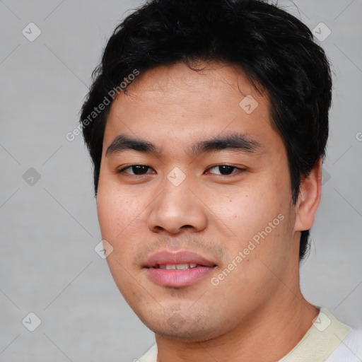 Joyful asian young-adult male with short  black hair and brown eyes