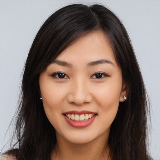 Joyful asian young-adult female with long  brown hair and brown eyes