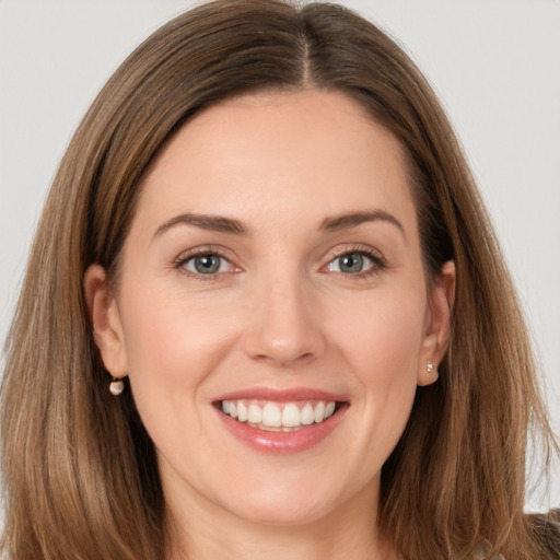 Joyful white young-adult female with long  brown hair and brown eyes