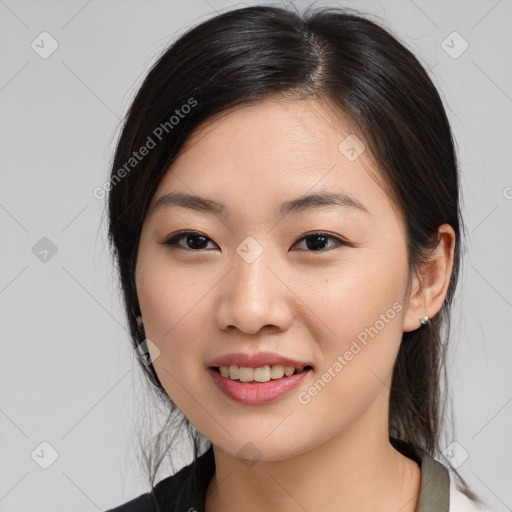 Joyful asian young-adult female with medium  black hair and brown eyes