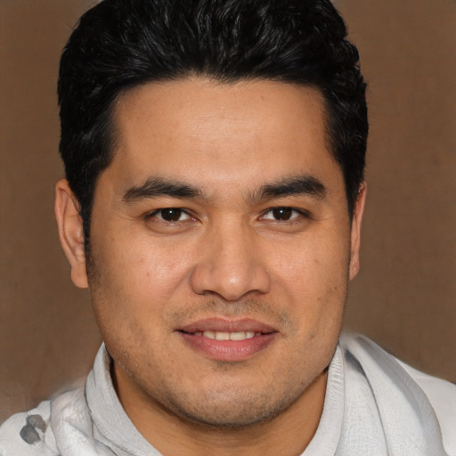 Joyful asian young-adult male with short  brown hair and brown eyes