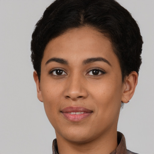 Joyful latino young-adult female with short  brown hair and brown eyes