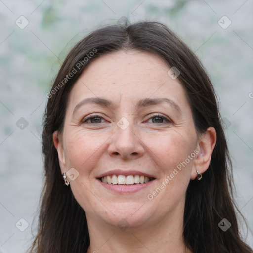 Joyful white adult female with long  brown hair and brown eyes