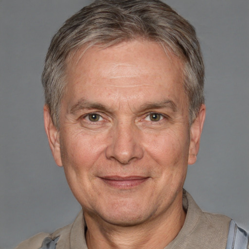 Joyful white middle-aged male with short  gray hair and brown eyes