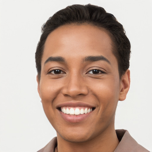 Joyful latino young-adult male with short  brown hair and brown eyes