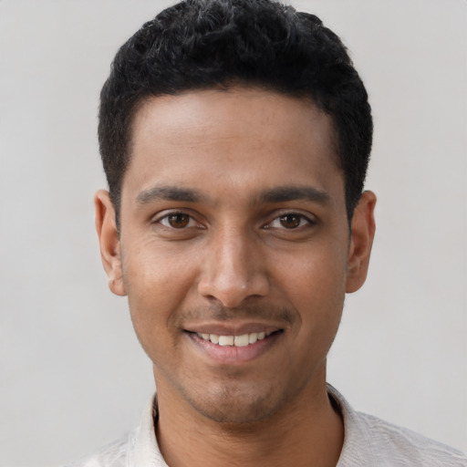 Joyful latino young-adult male with short  black hair and brown eyes