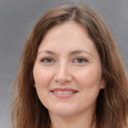 Joyful white adult female with long  brown hair and brown eyes