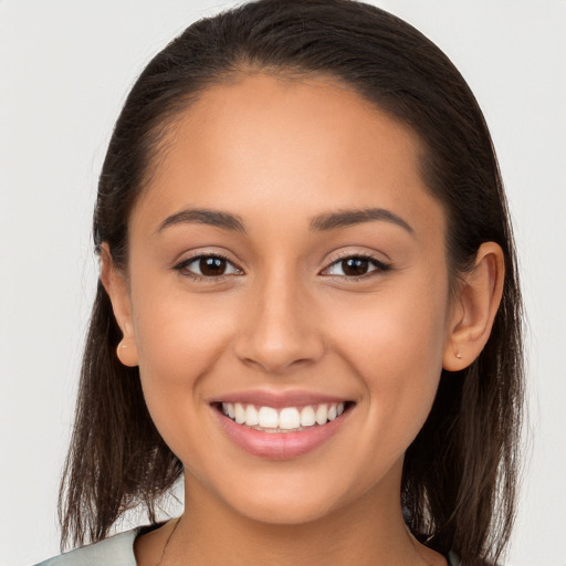 Joyful white young-adult female with long  brown hair and brown eyes