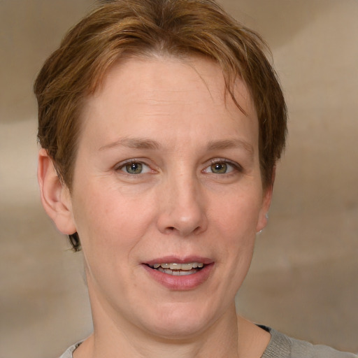 Joyful white adult female with short  brown hair and grey eyes