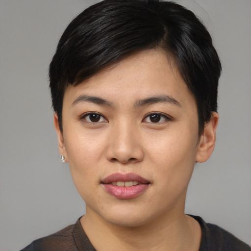 Joyful asian young-adult female with short  black hair and brown eyes