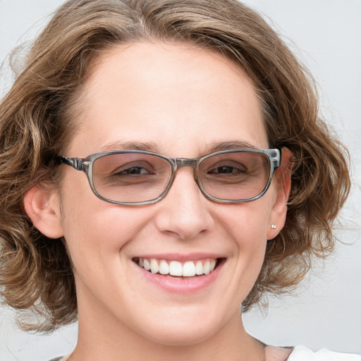 Joyful white adult female with medium  brown hair and blue eyes