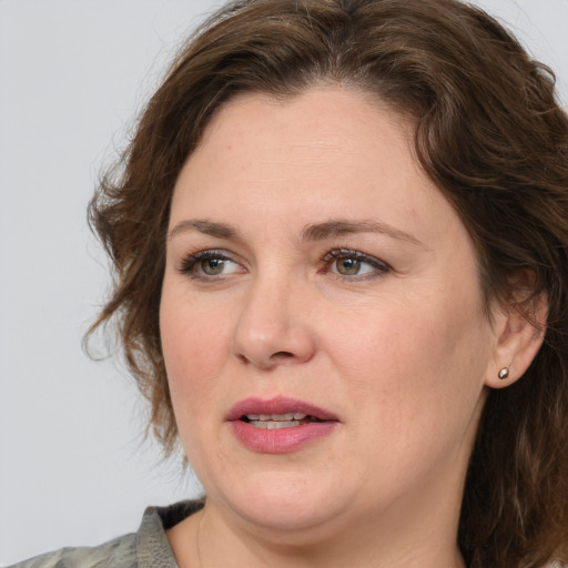 Joyful white adult female with medium  brown hair and grey eyes