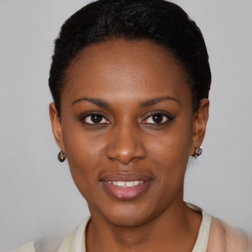 Joyful black young-adult female with short  brown hair and brown eyes