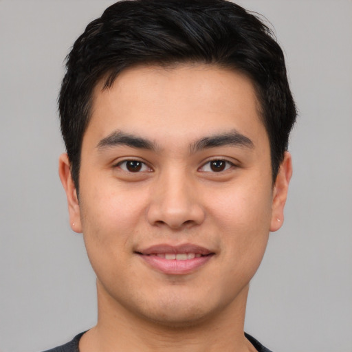 Joyful asian young-adult male with short  brown hair and brown eyes