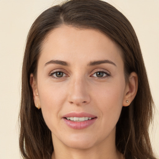 Joyful white young-adult female with long  brown hair and brown eyes