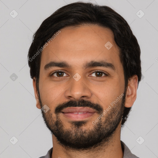 Joyful latino young-adult male with short  black hair and brown eyes