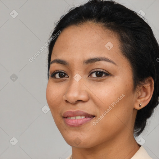 Joyful latino young-adult female with medium  brown hair and brown eyes