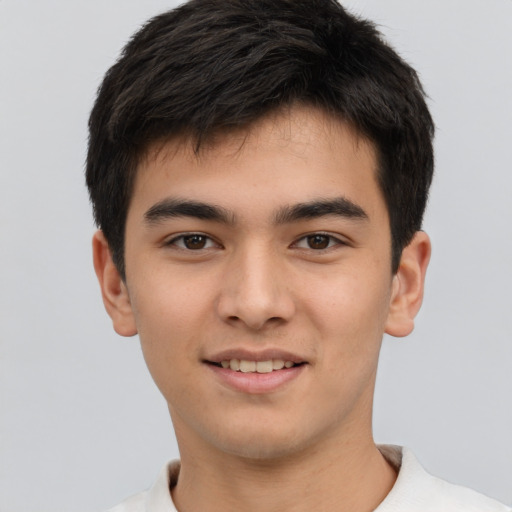 Joyful asian young-adult male with short  brown hair and brown eyes