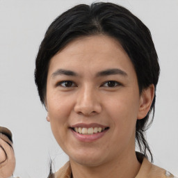 Joyful asian young-adult female with medium  black hair and brown eyes