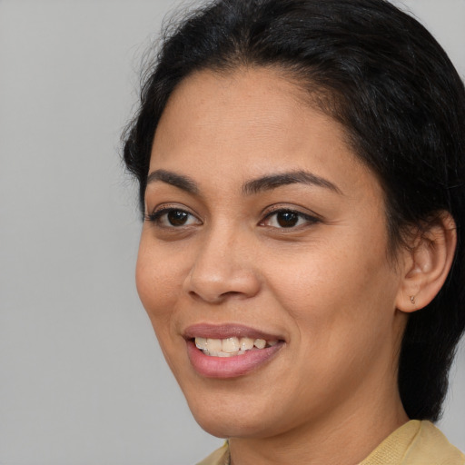 Joyful latino young-adult female with medium  brown hair and brown eyes