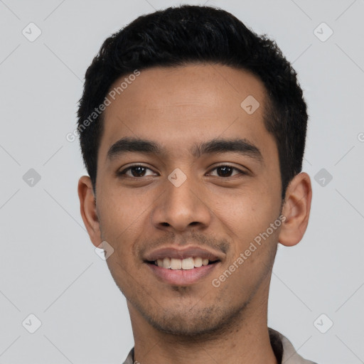 Joyful latino young-adult male with short  black hair and brown eyes