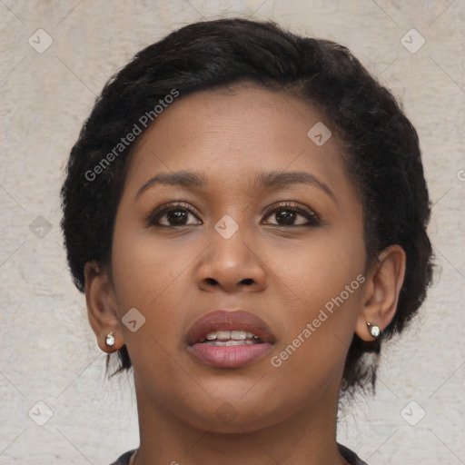 Joyful black young-adult female with short  black hair and brown eyes