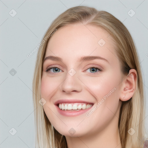 Joyful white young-adult female with long  brown hair and blue eyes