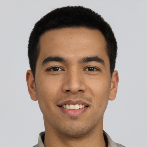 Joyful asian young-adult male with short  black hair and brown eyes