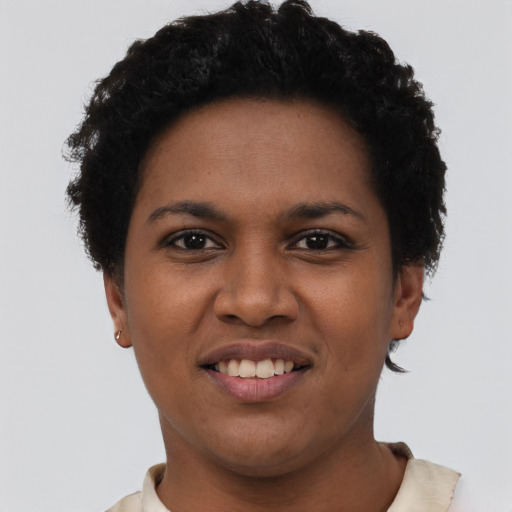 Joyful black young-adult female with short  black hair and brown eyes