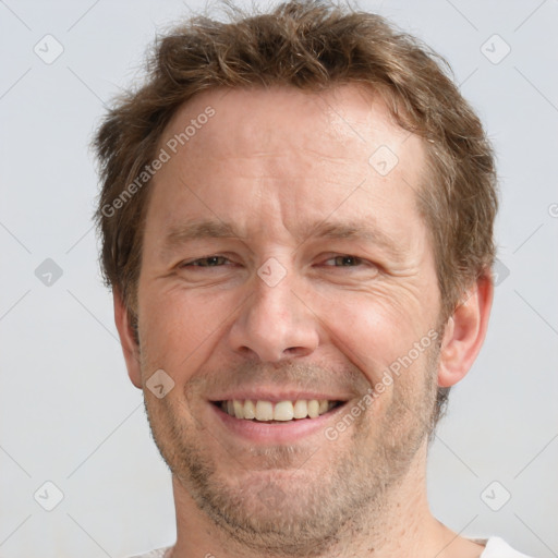 Joyful white adult male with short  brown hair and grey eyes