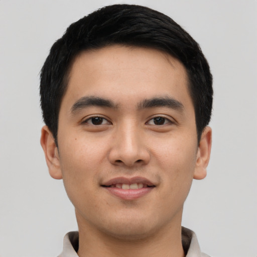 Joyful asian young-adult male with short  black hair and brown eyes