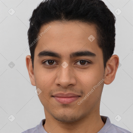 Joyful latino young-adult male with short  brown hair and brown eyes