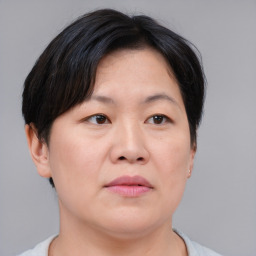 Joyful asian adult female with short  brown hair and brown eyes