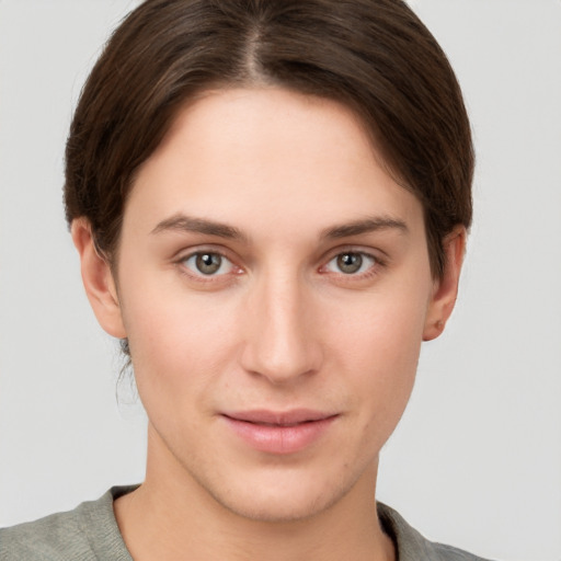 Joyful white young-adult female with short  brown hair and grey eyes