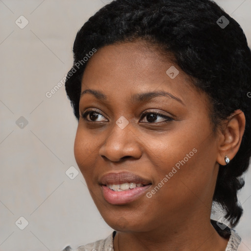 Joyful black young-adult female with short  black hair and brown eyes