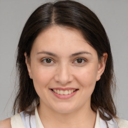 Joyful white young-adult female with medium  brown hair and brown eyes