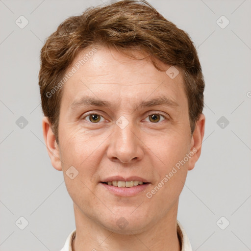 Joyful white adult male with short  brown hair and grey eyes